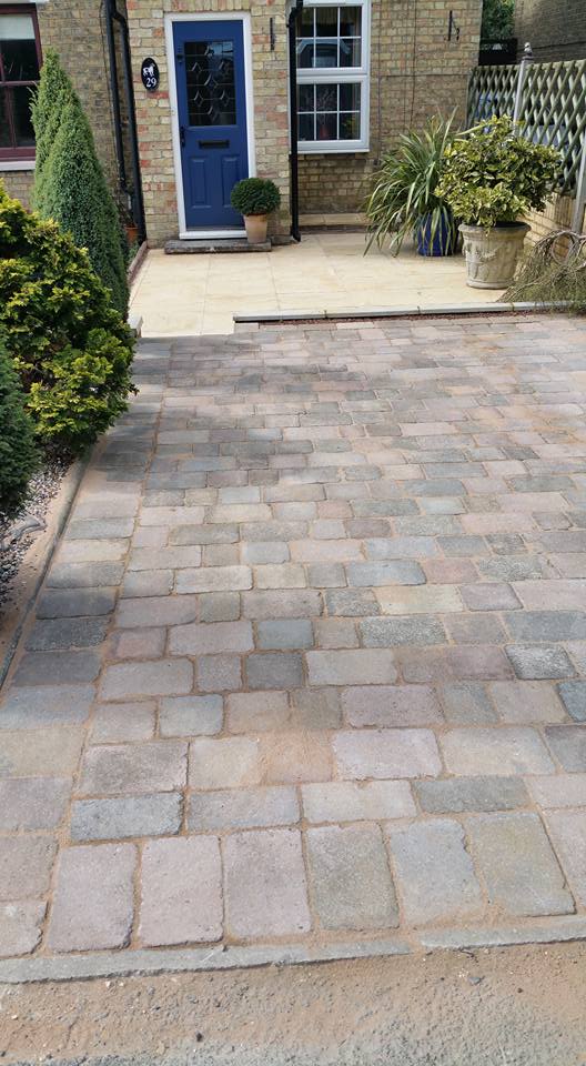 Dig out existing driveway and paved area, new paving slabs laid on lower level with rustic block pavers to top section.